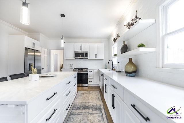 kitchen with white cabinets, backsplash, and appliances with stainless steel finishes