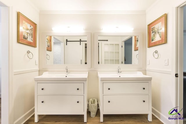 bathroom featuring hardwood / wood-style floors, vanity, and crown molding