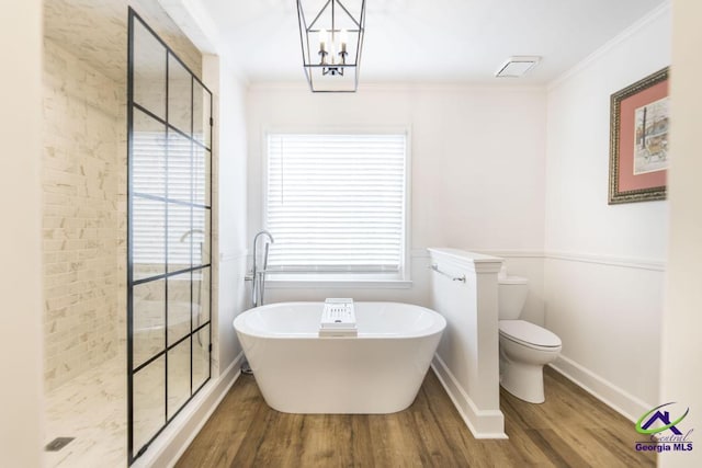 bathroom featuring a notable chandelier, separate shower and tub, crown molding, toilet, and hardwood / wood-style flooring