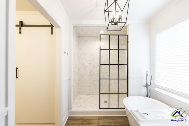 bathroom featuring plus walk in shower, wood-type flooring, an inviting chandelier, and ornamental molding