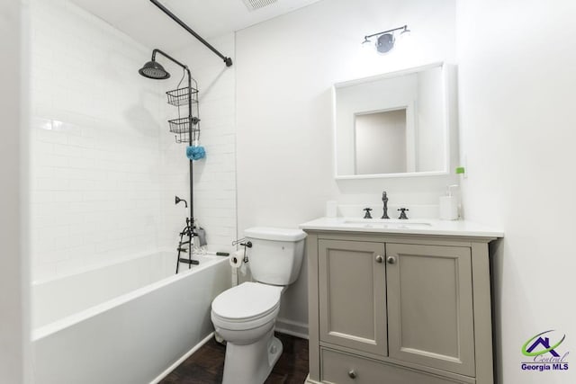 full bathroom featuring vanity, hardwood / wood-style flooring, toilet, and tiled shower / bath