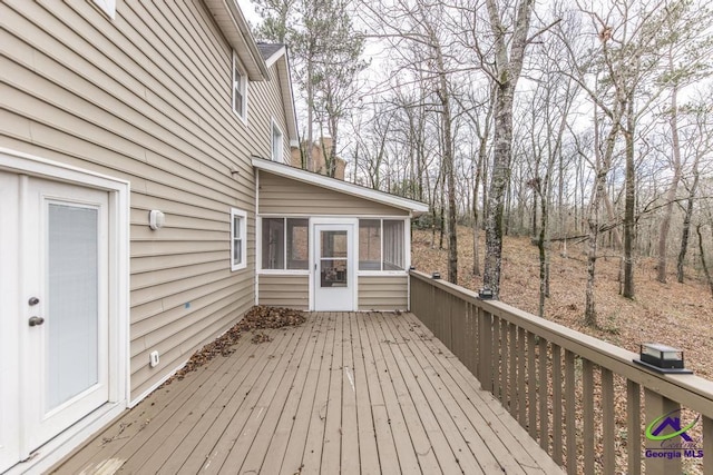 wooden deck with a sunroom