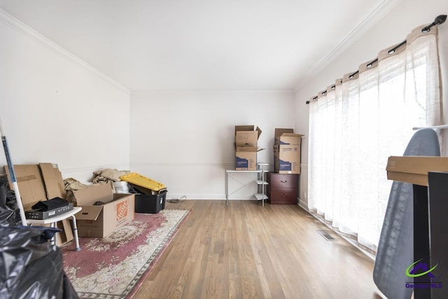 misc room with hardwood / wood-style flooring and crown molding