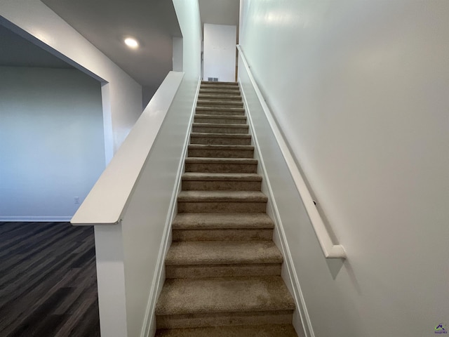 stairway featuring wood-type flooring