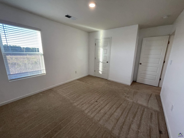 unfurnished bedroom featuring carpet floors and a closet