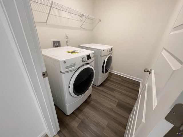 laundry area featuring washing machine and dryer and dark wood-type flooring