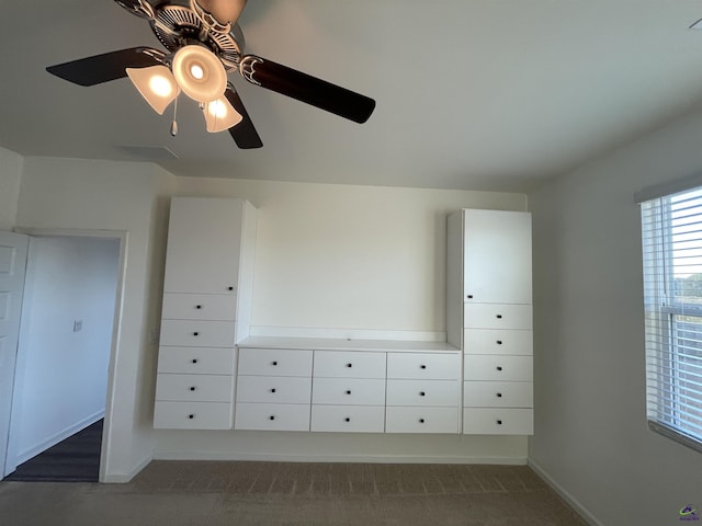 unfurnished bedroom featuring dark colored carpet and ceiling fan