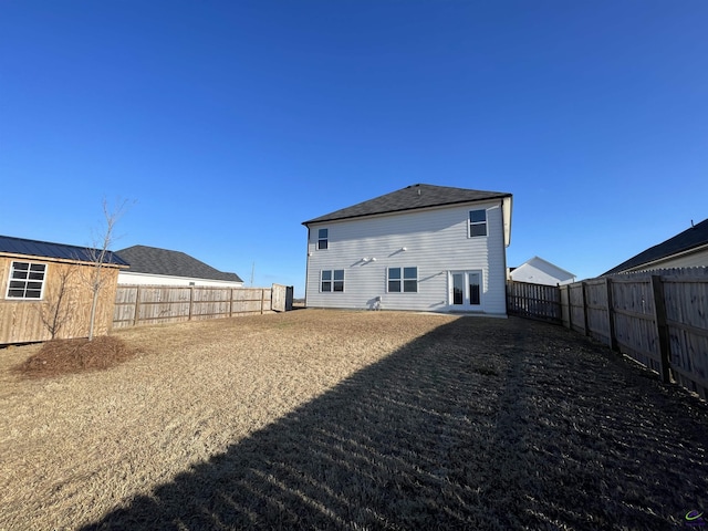 rear view of house with french doors and an outdoor structure