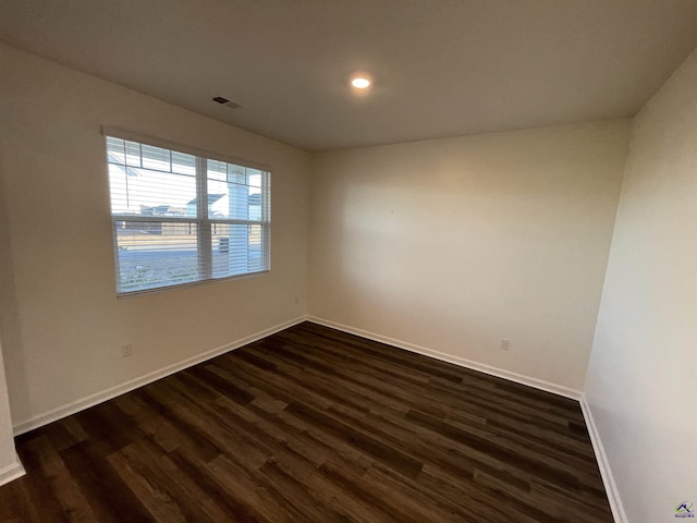 unfurnished room with dark hardwood / wood-style flooring