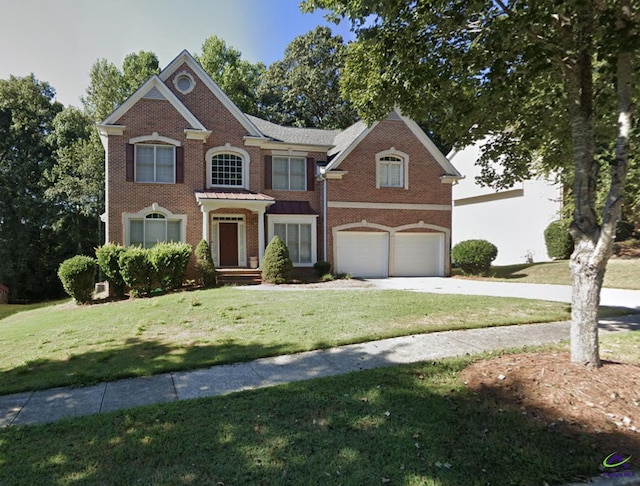 view of front of home featuring a front yard and a garage