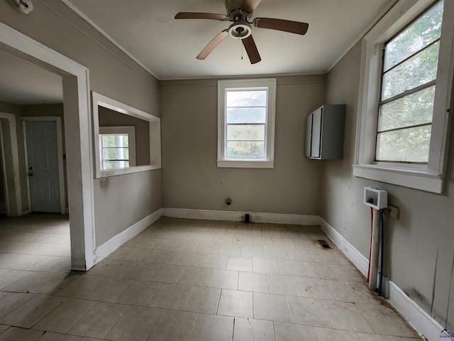 empty room featuring crown molding and ceiling fan