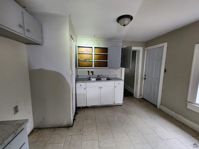 kitchen featuring white cabinetry, ornamental molding, and sink