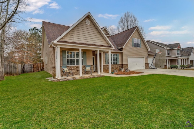 view of front of property featuring a front yard, a porch, and a garage