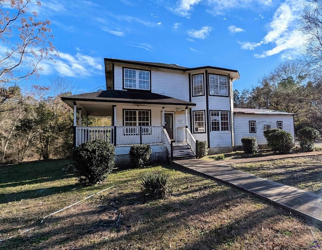 view of front facade with a front yard and a porch