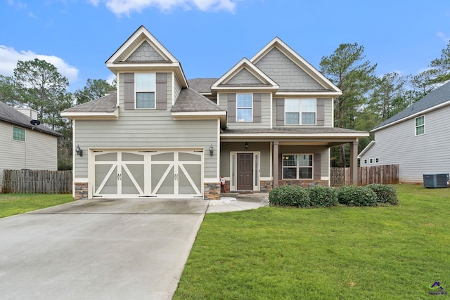 craftsman inspired home with central AC, a front yard, and a garage