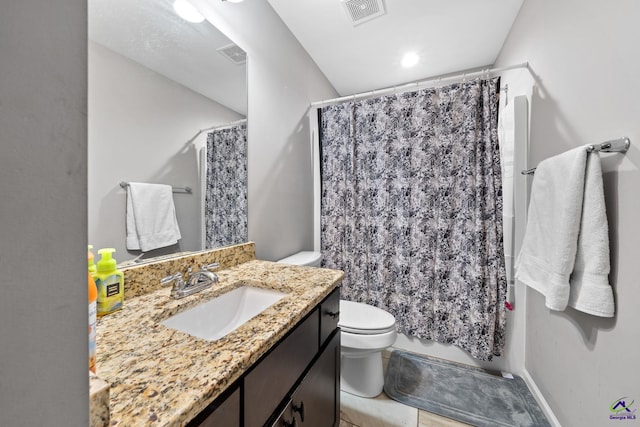 bathroom featuring walk in shower, tile patterned floors, vanity, and toilet