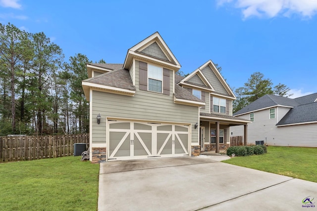 craftsman-style home featuring central AC, a front yard, and a garage