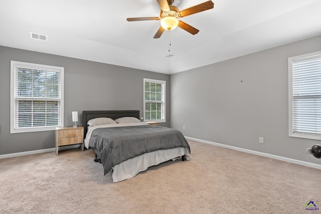 bedroom with ceiling fan and light carpet