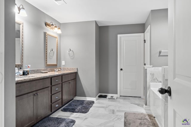 bathroom with vanity and a tub