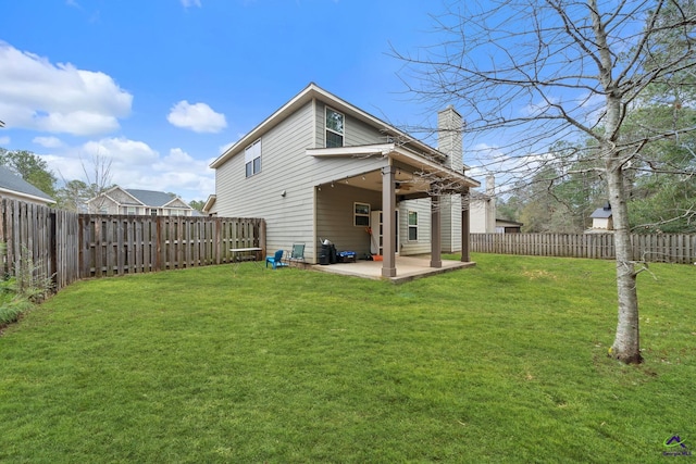 back of house with ceiling fan, a yard, and a patio