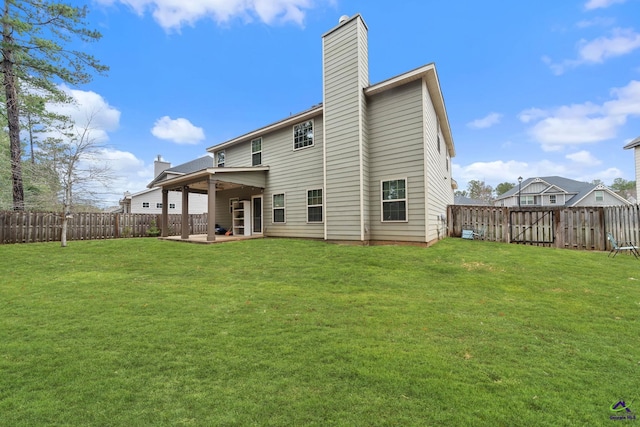 back of property with a yard and a patio