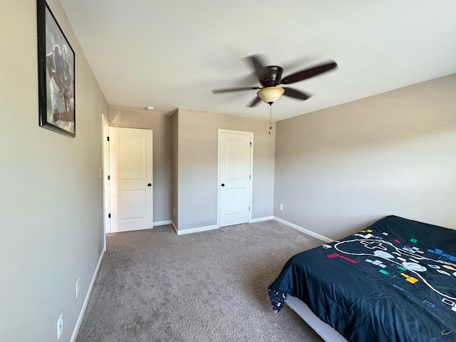 carpeted bedroom featuring a ceiling fan and baseboards