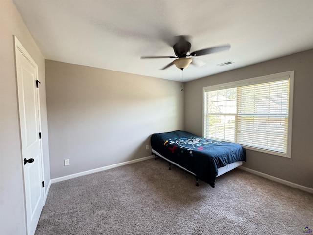 bedroom featuring carpet, visible vents, a ceiling fan, and baseboards
