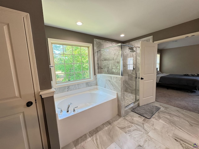 bathroom with a shower stall, a garden tub, ensuite bathroom, and recessed lighting