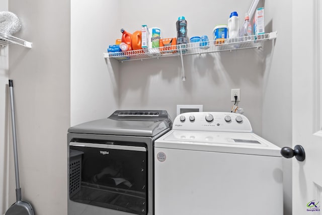 laundry room with washing machine and clothes dryer