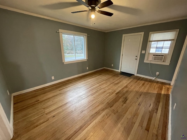 empty room with cooling unit, light hardwood / wood-style flooring, ceiling fan, and crown molding