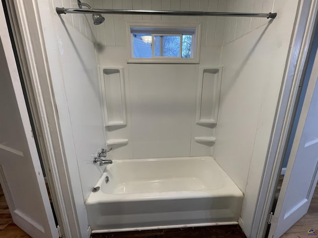 bathroom with shower / washtub combination and hardwood / wood-style flooring