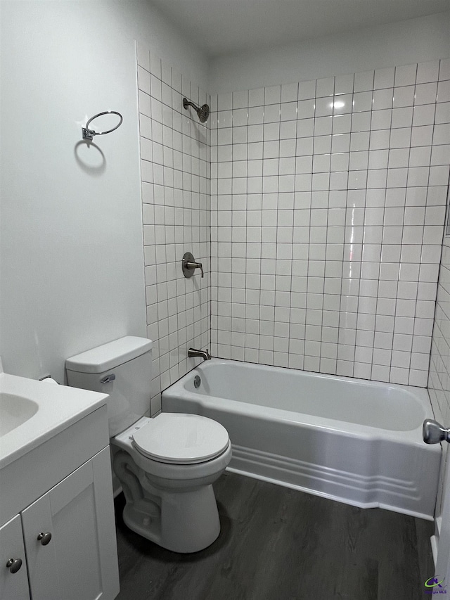 full bathroom with wood-type flooring, vanity, toilet, and tiled shower / bath