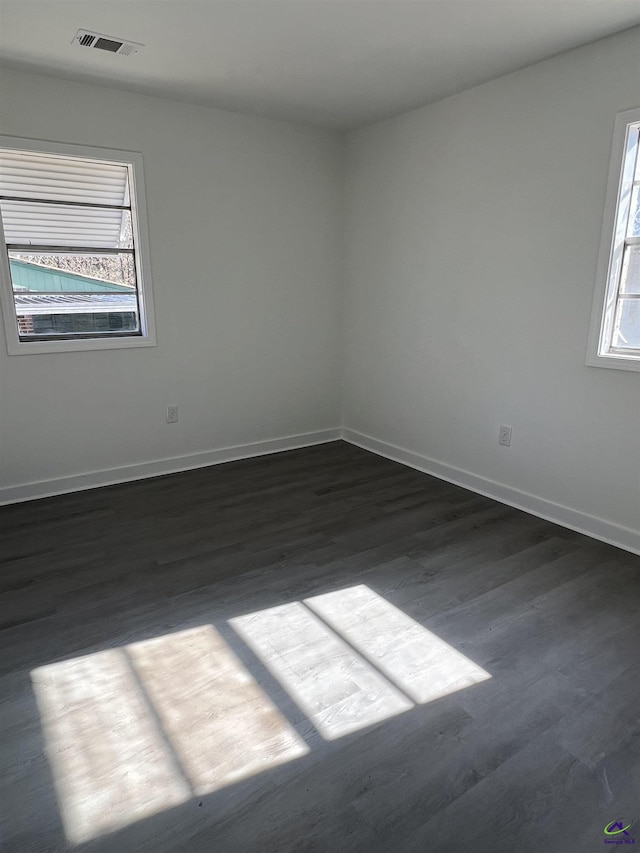 spare room with dark hardwood / wood-style flooring