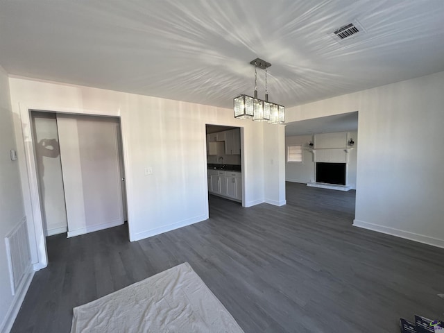 interior space with dark hardwood / wood-style floors, sink, and an inviting chandelier