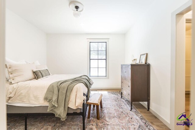 bedroom with hardwood / wood-style flooring