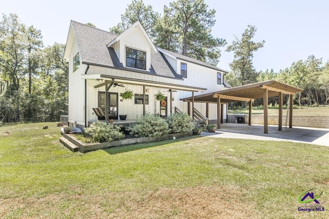 back of property with a lawn and covered porch