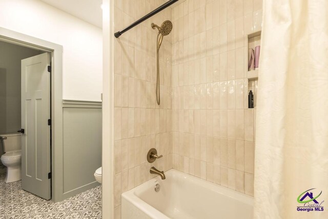 bathroom with shower / tub combo, toilet, and tile patterned floors