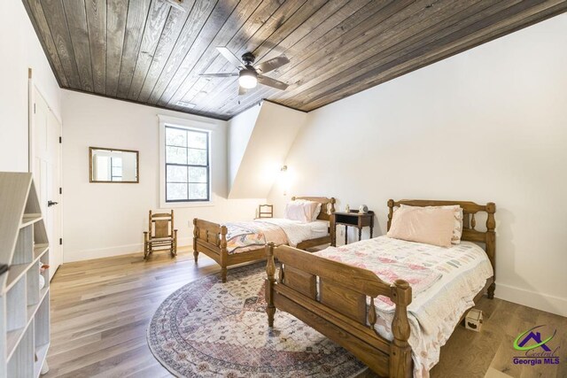 bedroom with ceiling fan, wood ceiling, and light hardwood / wood-style floors