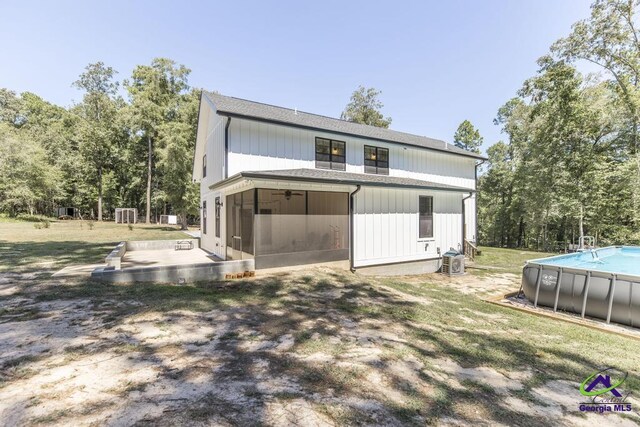 back of property featuring a patio area and a yard