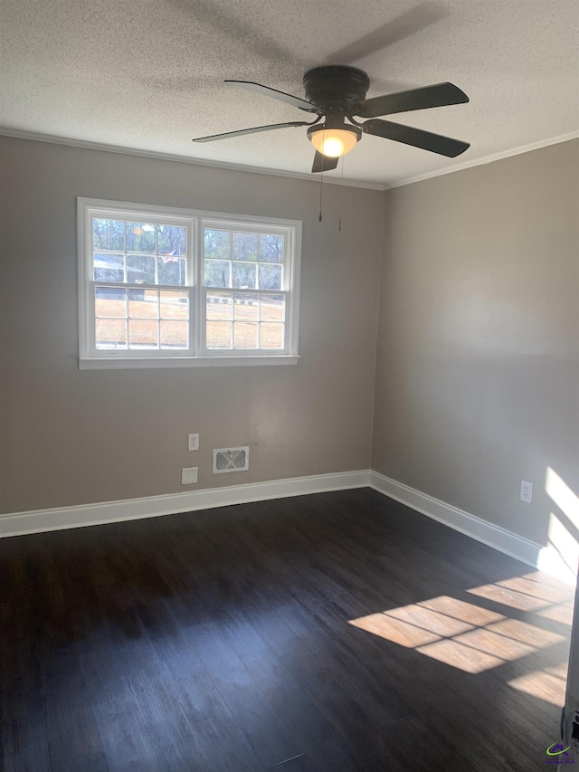 empty room featuring ceiling fan, ornamental molding, a textured ceiling, and dark hardwood / wood-style flooring