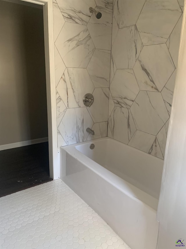 bathroom featuring tiled shower / bath combo and tile patterned floors