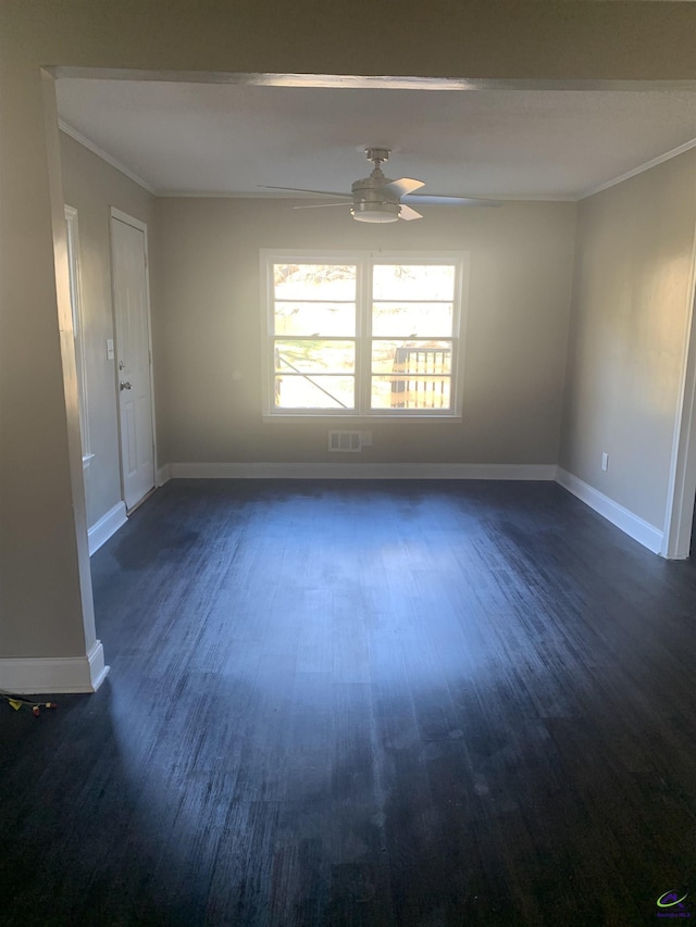 empty room with crown molding, ceiling fan, and dark wood-type flooring