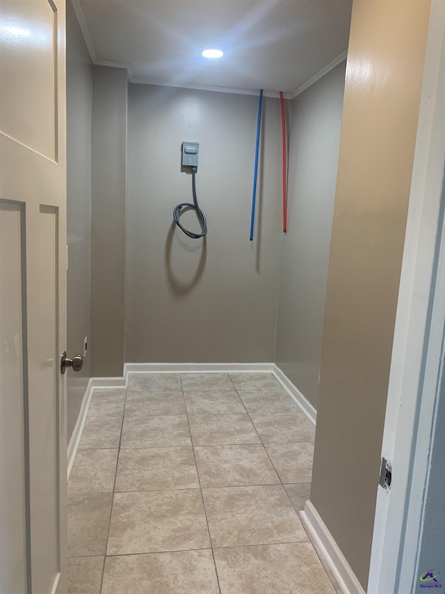 interior space featuring ornamental molding and light tile patterned flooring