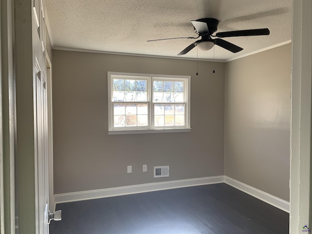 spare room with ornamental molding, dark hardwood / wood-style floors, and a textured ceiling