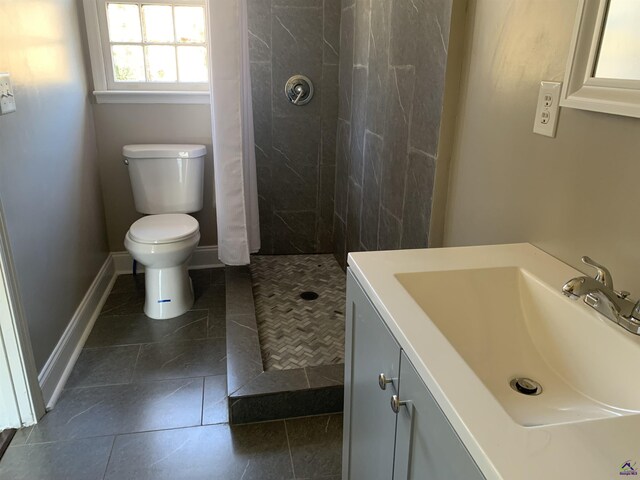 bathroom featuring vanity, toilet, and walk in shower