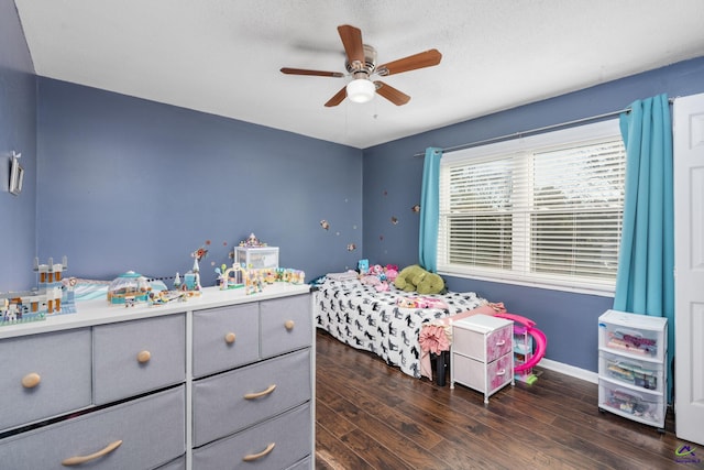 bedroom featuring a textured ceiling, ceiling fan, and dark hardwood / wood-style flooring