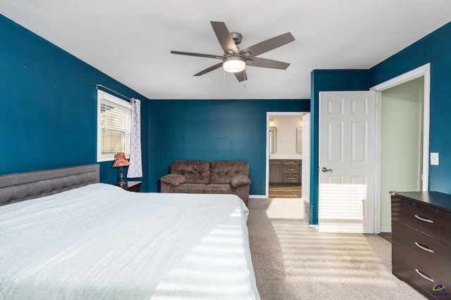 carpeted bedroom with ceiling fan and connected bathroom