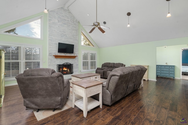 living room featuring dark hardwood / wood-style floors, high vaulted ceiling, ceiling fan, beamed ceiling, and a stone fireplace