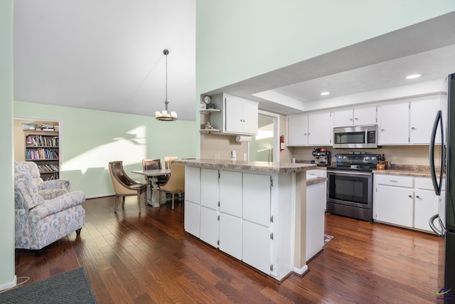 kitchen featuring stainless steel appliances, white cabinets, kitchen peninsula, hanging light fixtures, and dark wood-type flooring