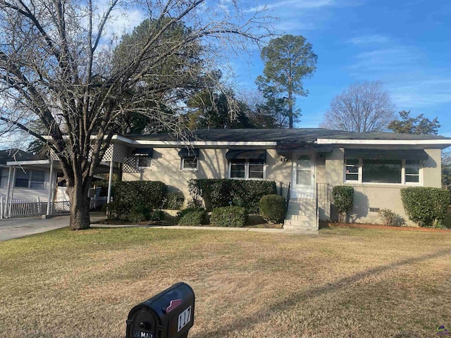 ranch-style home with a carport and a front yard